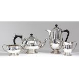 A George V silver circular four-piece tea service with moulded rims and part fluted bodies, scroll