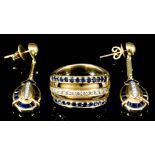 An 18ct gold mounted three band diamond and sapphire ring, the central band set with small diamonds,