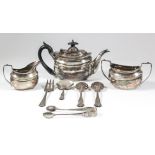 An Edward VII bachelors silver oval three-piece tea service with reeded rims and moulded bodies,