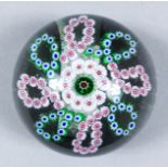 A mid-19th Century French glass paperweight, with single layer ribbon pattern millefiori, 3ins