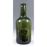 A late 18th Century green glass sealed wine bottle of cylindrical form, the whole of olive green