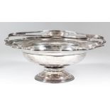 A George V silver circular basket with shaped and moulded rim and shaped, pierced and reeded handle,