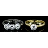 An 18ct white gold mounted three stone diamond ring, set with three round brilliant cut diamonds (