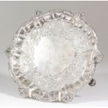 A George II silver circular waiter, the shaped and moulded rim with shell castings, the centre