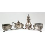 A George V silver circular four-piece condiment set with shaped and reeded rims, the bulbous