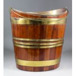 A 19th Century Dutch brass bound mahogany bucket of oval outline, with swing handle and brass liner,