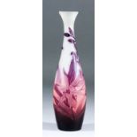 An early 20th Century Galle mauve overlay cameo glass vase of slender baluster form, cut with