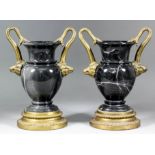 A pair of gilt metal mounted black-marble urn-shaped two-handled vases with boar's head terminals,