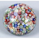 A mid 19th Century Baccarat close packed millefiori glass paperweight with gridel silhouettes,