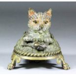 A late 19th/early 20th Century brass and painted metal table bell modelled in the form of a cat in a