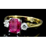 A modern gold coloured metal mounted ruby and diamond three stone ring, set with a rectangular