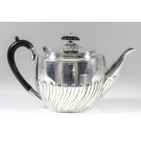 A late Victorian silver oval teapot with partly spiral reeded body with ebonised handle, 6ins