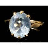 A modern 9ct gold mounted aquamarine oval ring, set with a facet cut aquamarine stone (approximately