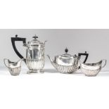 A late Victorian silver cylindrical and part reeded hot water pot with angular ebonised handle and