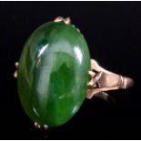 A modern 18ct gold mounted jade ring, set with oval cabochon jade stone, approximately 18mm x