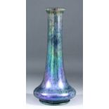 A late 19th/early 20th Century Austrian iridescent glass vase in the Loetz manner, with squat