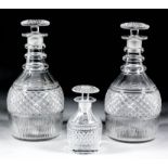 A pair of early 19th Century English glass decanters with triple ringed necks, 9ins high, and