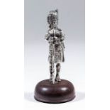 An early 20th Century cast silver model of a Scottish Highlander, 4ins high, by Mappin & Webb,