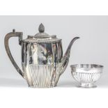 A late Victorian silver oval coffee pot with reentrant corners, gadroon mounts and part reeded body,