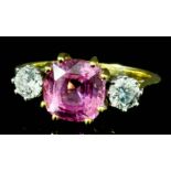 A modern 18ct gold mounted pink sapphire and diamond three stone ring, set with an octagonal cut