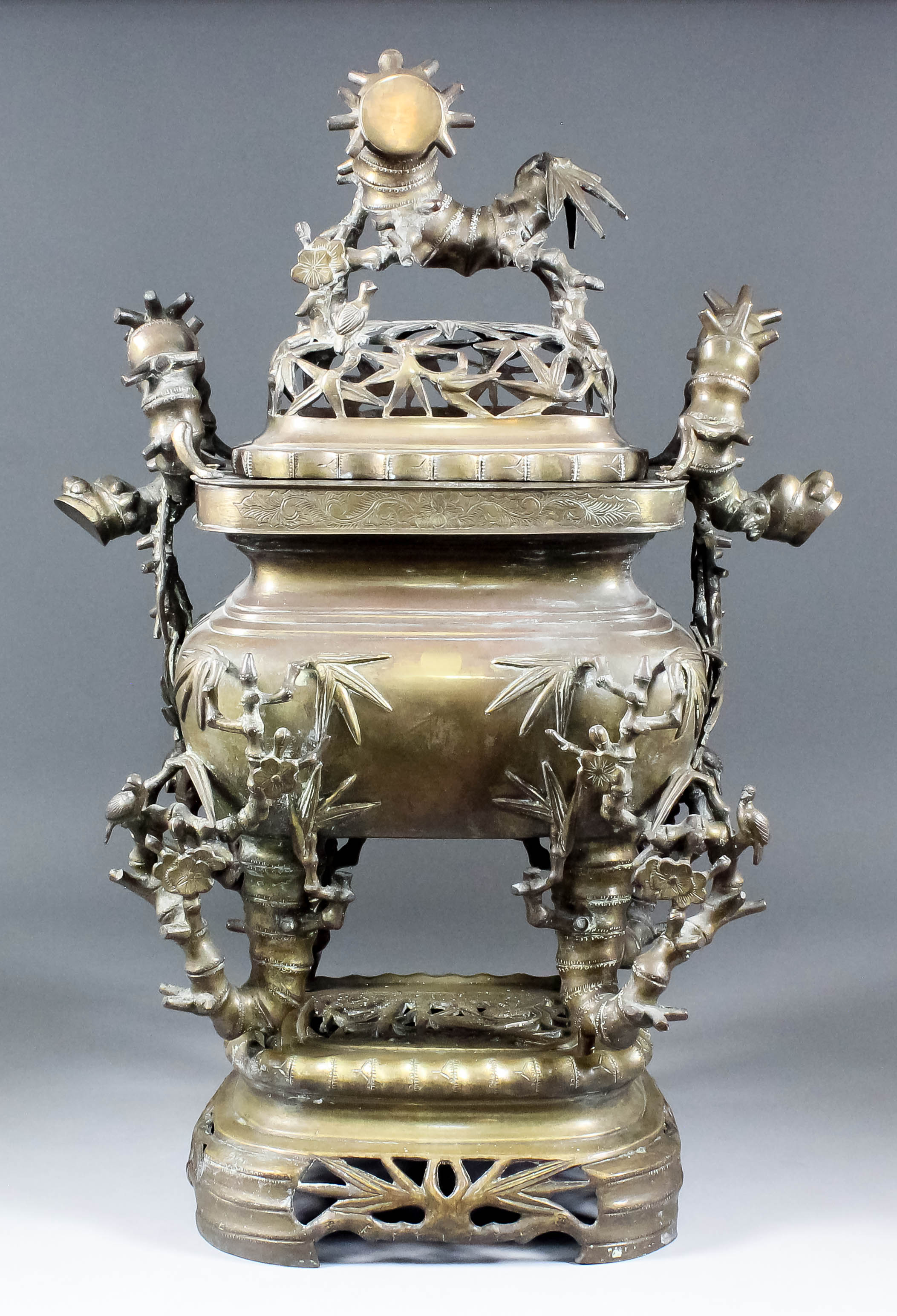 A Chinese cast brass rectangular two-handled koro, cover and stand, the pierced cover with dragon