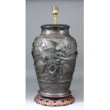 A Japanese brown patinated bronze vase, cast with exotic birds amongst rock work and blossoms, 13.
