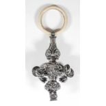 A late Victorian child's silver rattle, the body cast with C-scroll and floral ornament, with