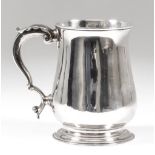 A George III silver baluster shaped tankard with moulded rim and footrim and with leaf capped