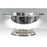 An early 20th Century silver circular bowl, the shaped and moulded rim with scroll and leaf