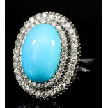 A modern 18ct white gold mounted turquoise and diamond oval ring, set with central turquoise