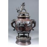 A Chinese brown patinated bronze two-handled koro, the domed cover with mythical beast finial, the