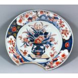 A late 17th/early 18th Century Japanese Imari porcelain Barber's bowl, the centre painted with a