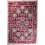 A Bakhtiari carpet woven in colours with a central trellis design filled with leaf and floral