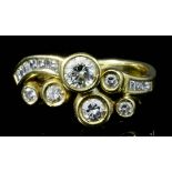 A modern 18ct gold mounted diamond ring, set with five round brilliant cut diamonds in collet