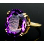 A modern 9ct gold mounted amethyst ring, set with an oval facet cut amethyst (approximately 8ct), (