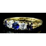 A late Victorian 18ct gold mounted five stone sapphire and diamond ring, set with three old cut