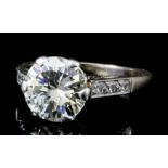 A silvery coloured metal mounted solitaire diamond ring with central diamond (approximately 2ct),