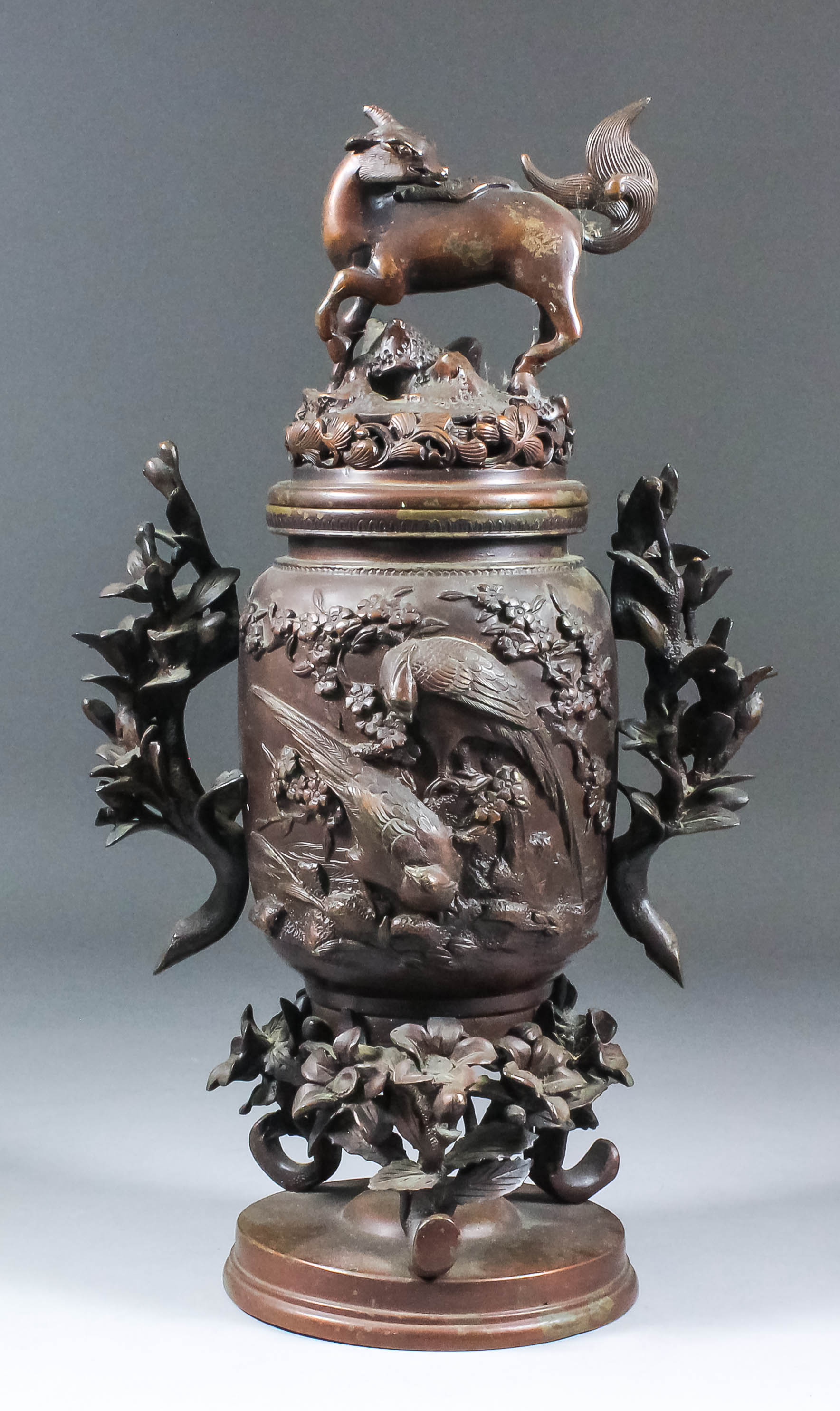 A Chinese brown patinated two-handled koro and cover with deer pattern finial, the body cast in bold