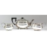 A George V silver rectangular three-piece tea service with gadroon mounts, moulded bulbous body,