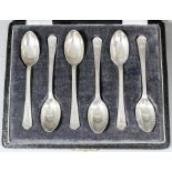 A set of six George VI silver coffee spoons with reeded handles and shaped terminals, by Walker &