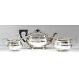 A George V silver rectangular three-piece tea service with gadroon mounts, moulded bulbous bodies,