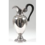 An early 19th Century French silver jug with plain urn shaped body, bead and acanthus mounts to rims