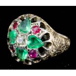 An Indian gold coloured metal mounted emerald, ruby and diamond set "Maharajah" ring, the centre