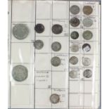A black vinyl album containing a selection of silver and bronze coins, including - Roman, hammered