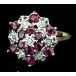 A modern 9ct gold mounted diamond and ruby cluster ring of flowerhead pattern, set with seven