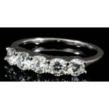 A modern silvery coloured metal mounted five stone diamond ring, set with round brilliant cut