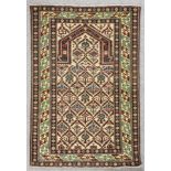 A modern Shirvan prayer rug, the central mihrab filled with a trellis of geometric motifs, within