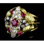 A gold coloured metal mounted ruby and diamond ovoid cluster ring, set with central oval ruby in