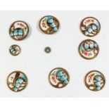 Seven French gilt metal and enamel circular buttons pierced and cast with stylised flowers and