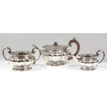 A good George IV silver three-piece tea service with squat circular octagonal lobed bodies, the